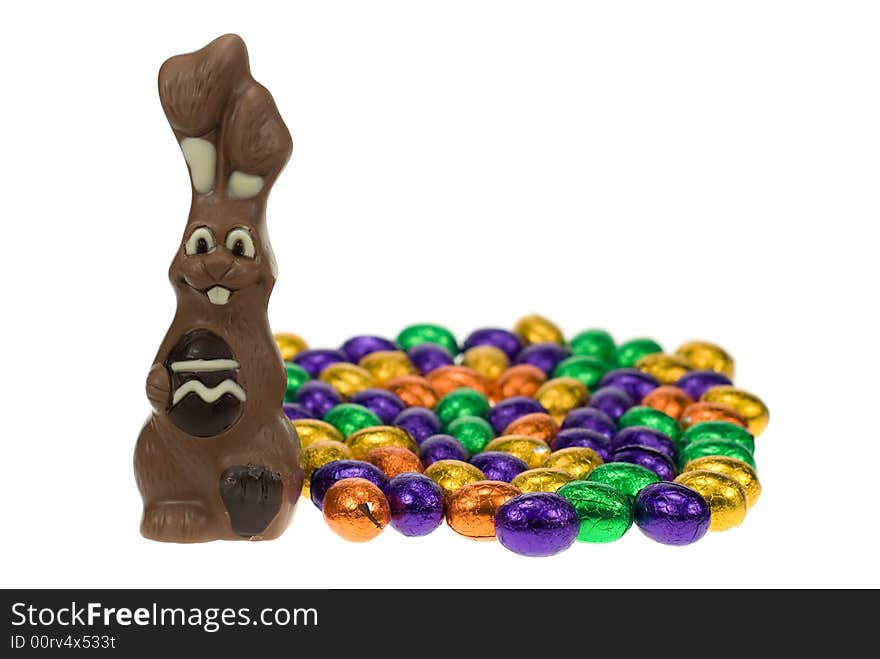 Cute easter bunny surrounded by easter eggs isolated on a white background