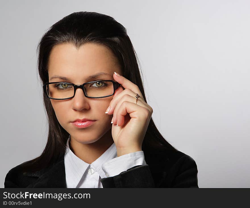 Smiling woman looking throw glasses on a white background. Smiling woman looking throw glasses on a white background