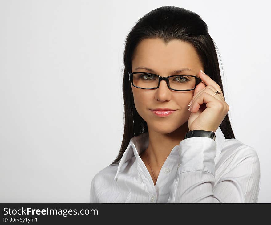 Smiling woman looking throw glasses on a white background. Smiling woman looking throw glasses on a white background