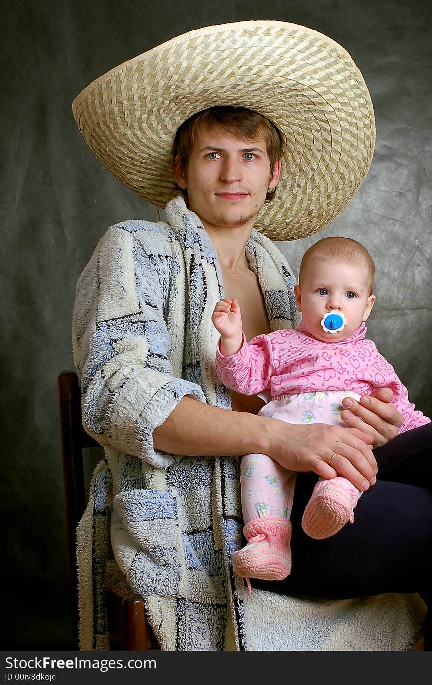 Father warmly holding his baby, portrait of a baby. Father warmly holding his baby, portrait of a baby