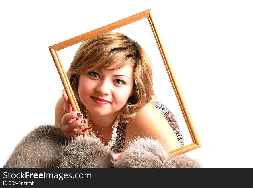 Woman laying on fur and holding a frame over her face. Woman laying on fur and holding a frame over her face