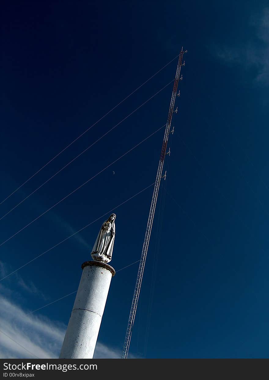 Statue of Our Lady of Fatima in front of an antenna tower. Statue of Our Lady of Fatima in front of an antenna tower.