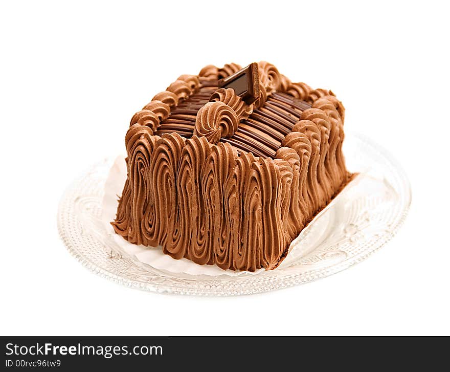 A beautifully decorated chocolate cake torte with a square of chocolate on top.