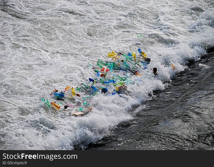 Plastic bottles trapped in the foam at the base of a waterfall.  Taken on the Tiber River in Rome, Italy. Plastic bottles trapped in the foam at the base of a waterfall.  Taken on the Tiber River in Rome, Italy.