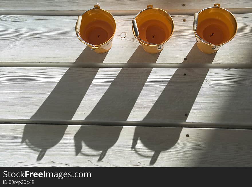 Orange utensils, shadow on a floor. Orange utensils, shadow on a floor.