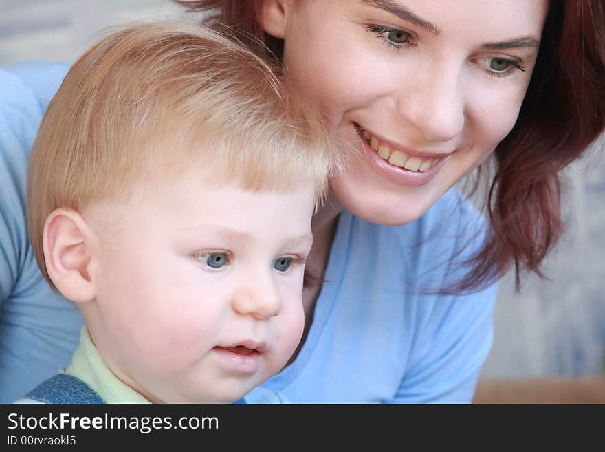 Young mum smiling with the small beautiful boy together look where that. Young mum smiling with the small beautiful boy together look where that