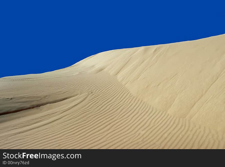 Sand Dune with Blue Sky Background