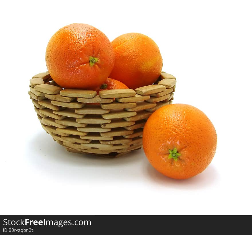 Oranges in wooden bowl on a white background