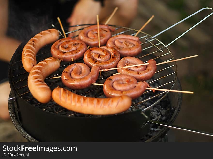 Rolled sausage and pork chops in the grill. Rolled sausage and pork chops in the grill