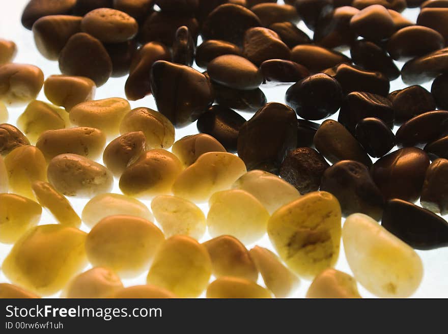 Pebbles two colors on a white background with illumination. Pebbles two colors on a white background with illumination