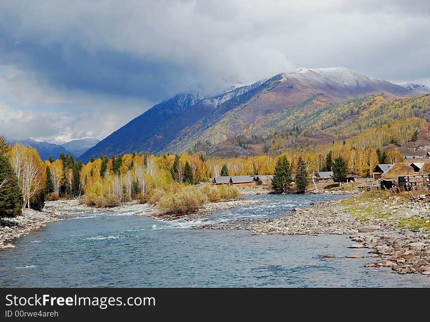 Hemu, with the beatiful mountain beauty moutain , HeMu river with trees and bank, this place is xinjiang, North of China. Hemu, with the beatiful mountain beauty moutain , HeMu river with trees and bank, this place is xinjiang, North of China