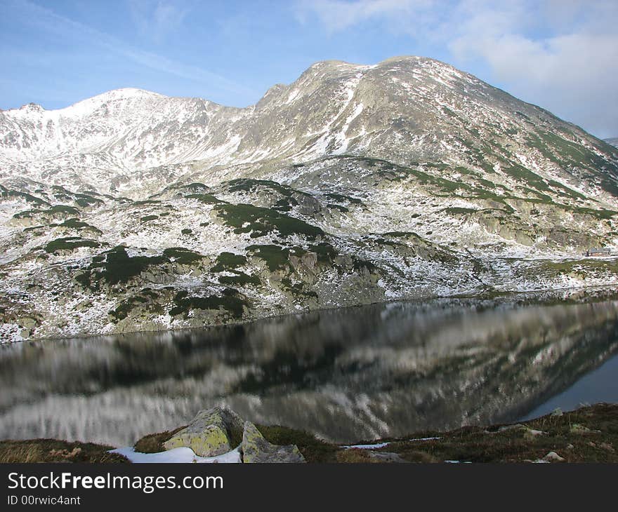 A mountain mirrored in a lake. A mountain mirrored in a lake