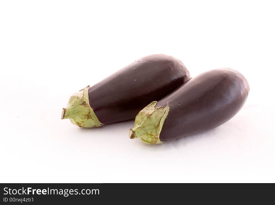 Two eggplants lying together on white. Two eggplants lying together on white