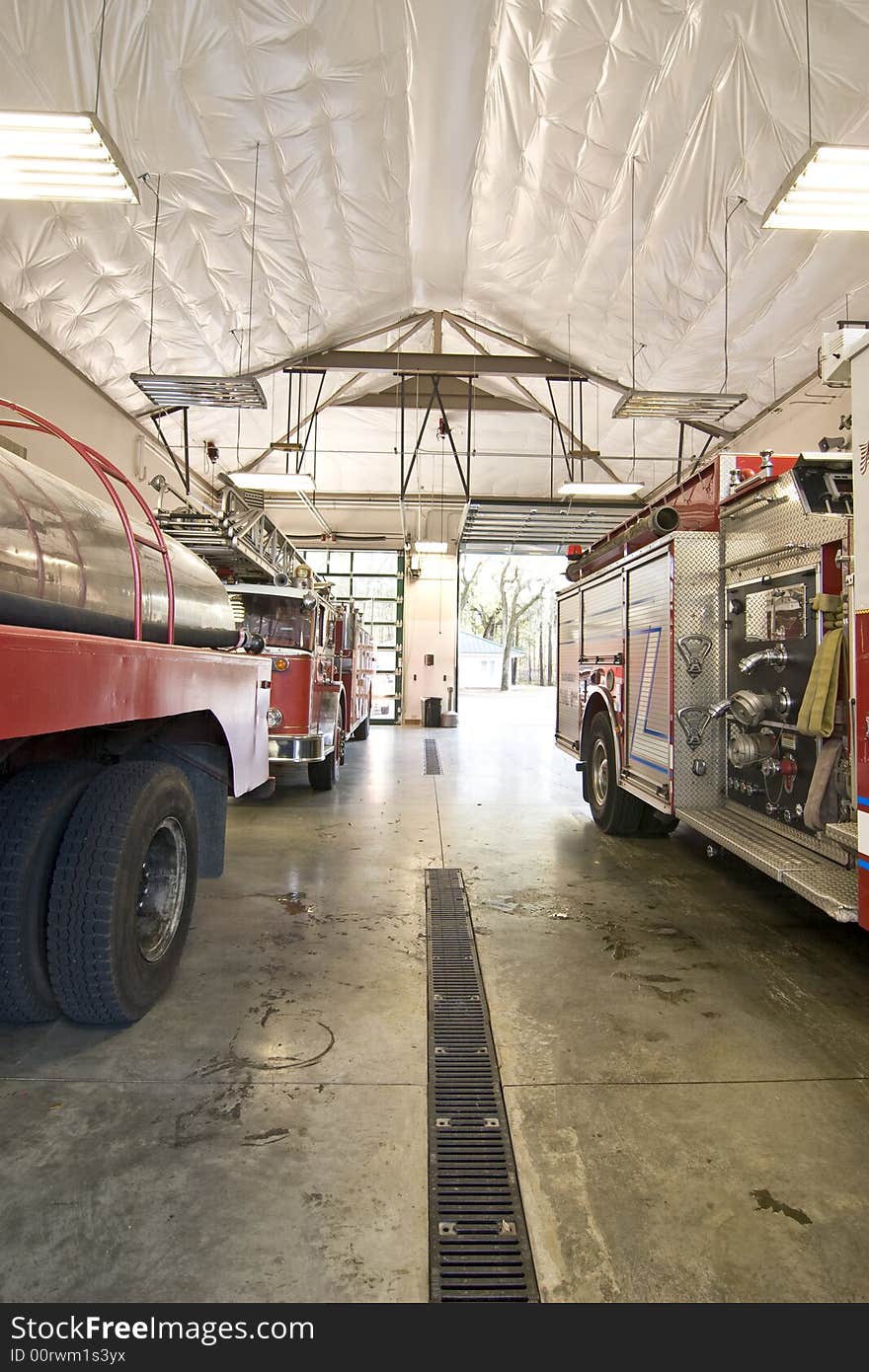 Fire engines in bay on the ready for a call. Fire engines in bay on the ready for a call.