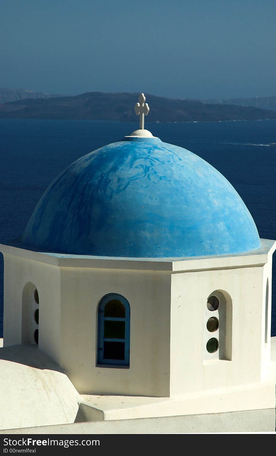 Blue domed church overlooking the sea in Santorini