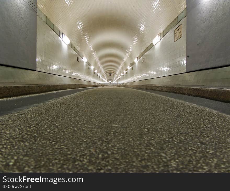 Tunnel in Hamburg, under the Elbe. Empty, lighted by fluorescent