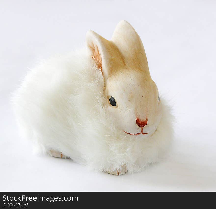 Little white easter rabbit on gray background. easter decoration