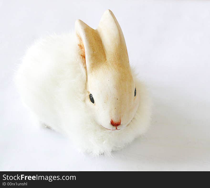 Little white easter rabbit on gray background. easter decoration