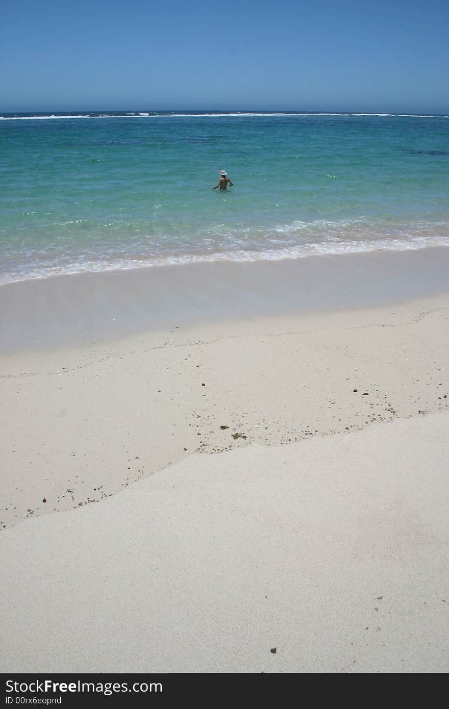 Beautiful view at sandy beach with one woman going to swim in a turquoise clear water. Australia. Beautiful view at sandy beach with one woman going to swim in a turquoise clear water. Australia.