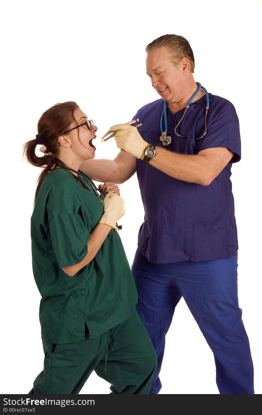 Mad dentist pulling tooth from nurse