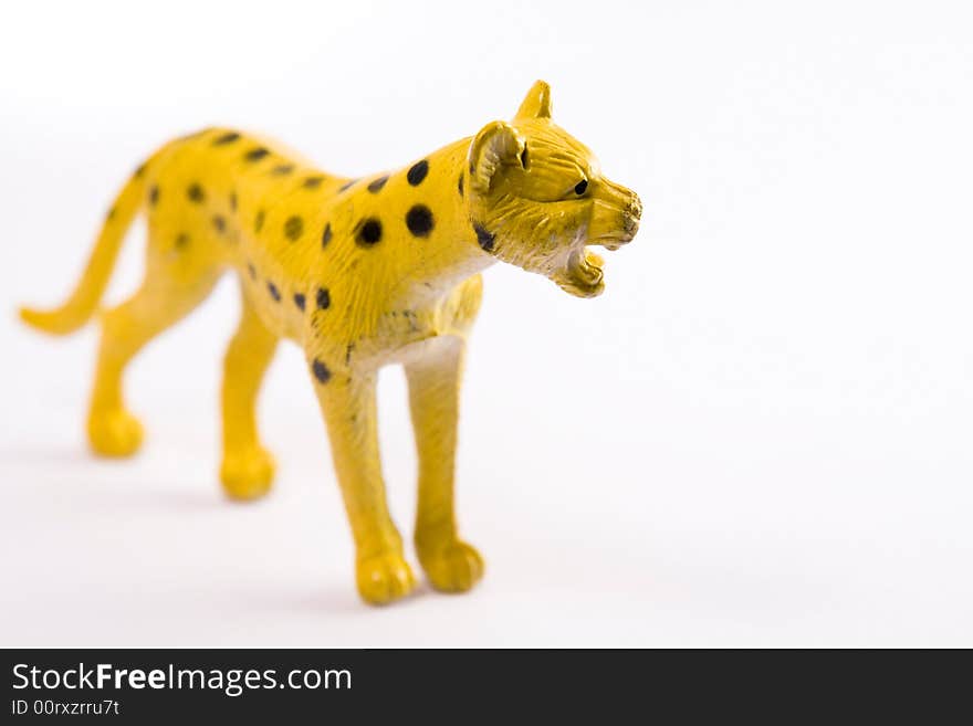 Single leopard figure toy macro white background. Single leopard figure toy macro white background