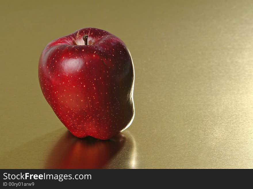 Red apple with golden background