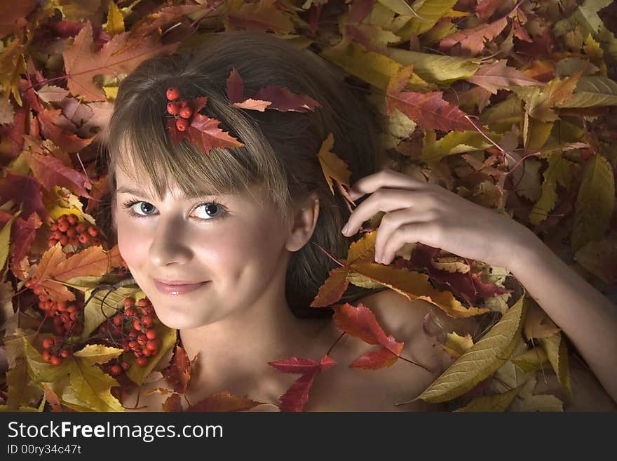 Portrait of a beautiful young girl in autumn leaves. Portrait of a beautiful young girl in autumn leaves