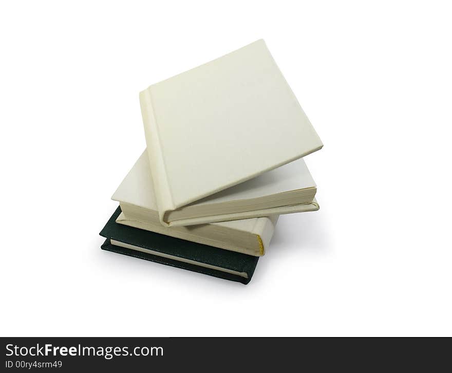 Three hardcover books lying on white background