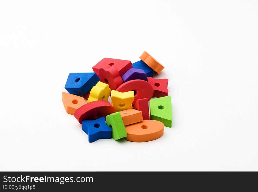 Multicolored toys in orange, red, green, purple and blue. Different shapes. Isolated on white background. Multicolored toys in orange, red, green, purple and blue. Different shapes. Isolated on white background.