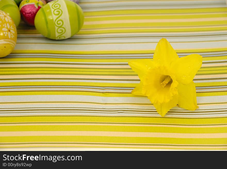 Flower head and easter eggs on a striped background. Flower head and easter eggs on a striped background.