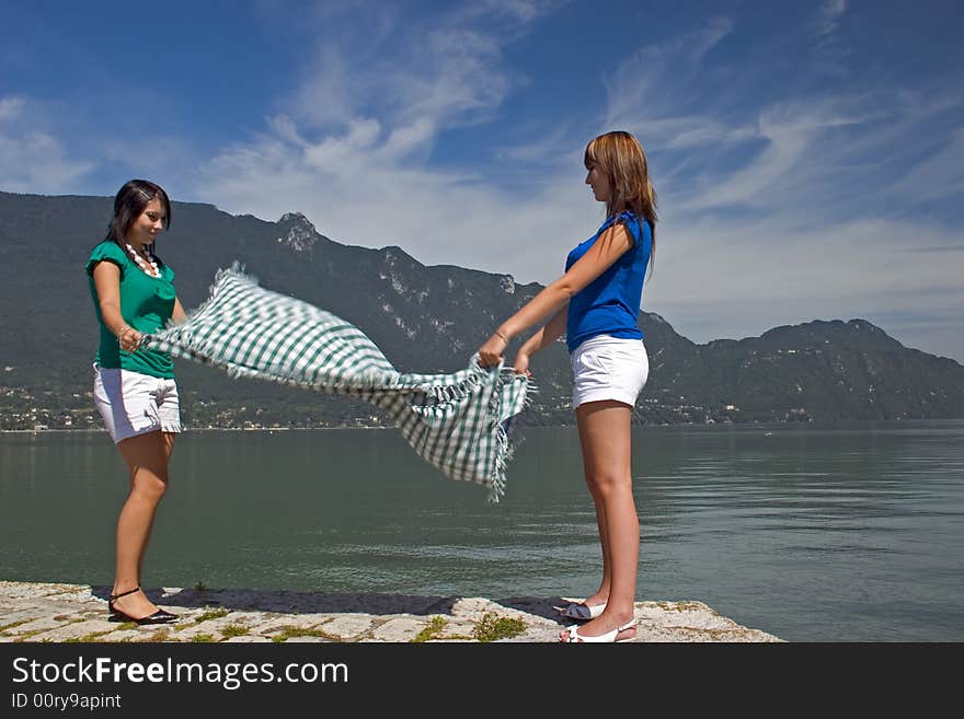 Woman extending a tablecloth