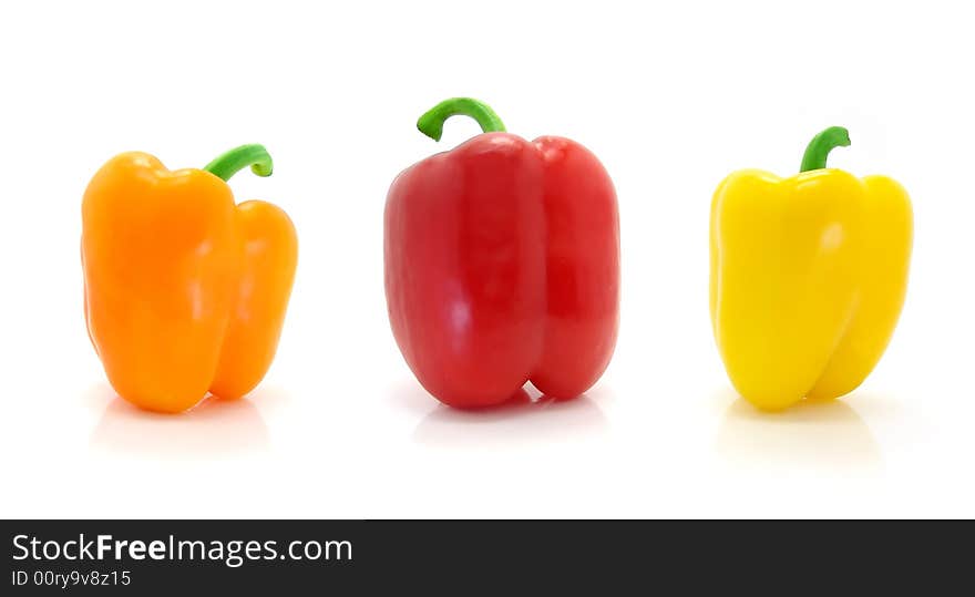 Colored peppers on white background