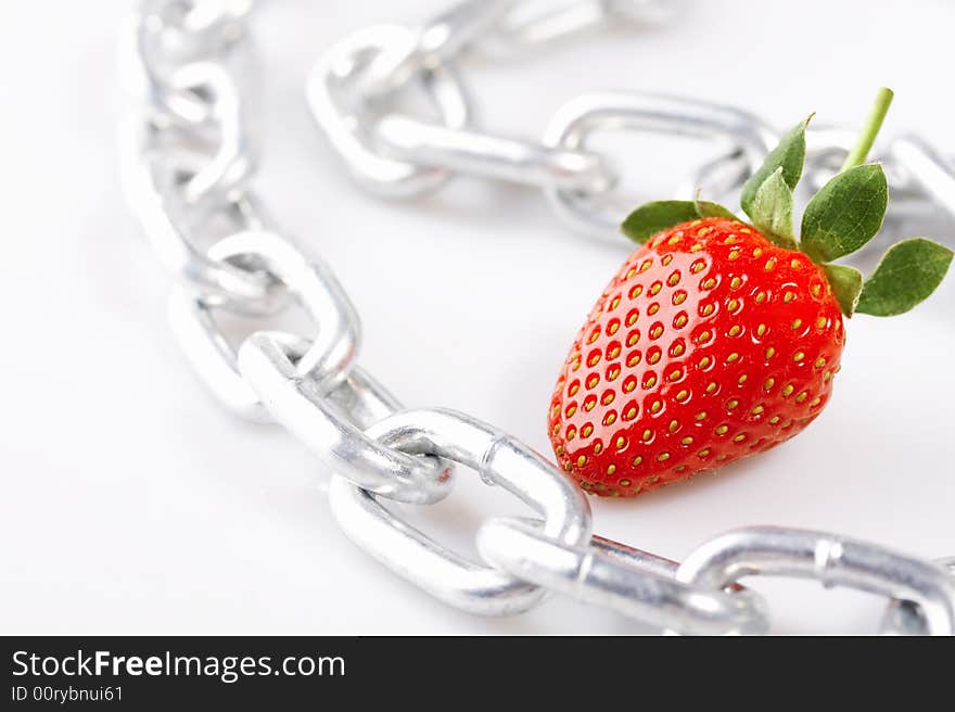 Strawberry laying on a white background among a chain. Strawberry laying on a white background among a chain