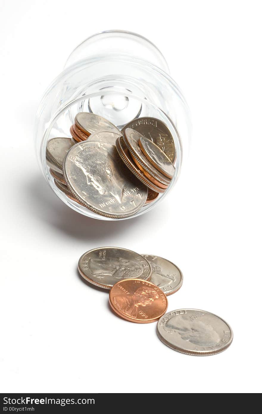 Coins in a glass on a white