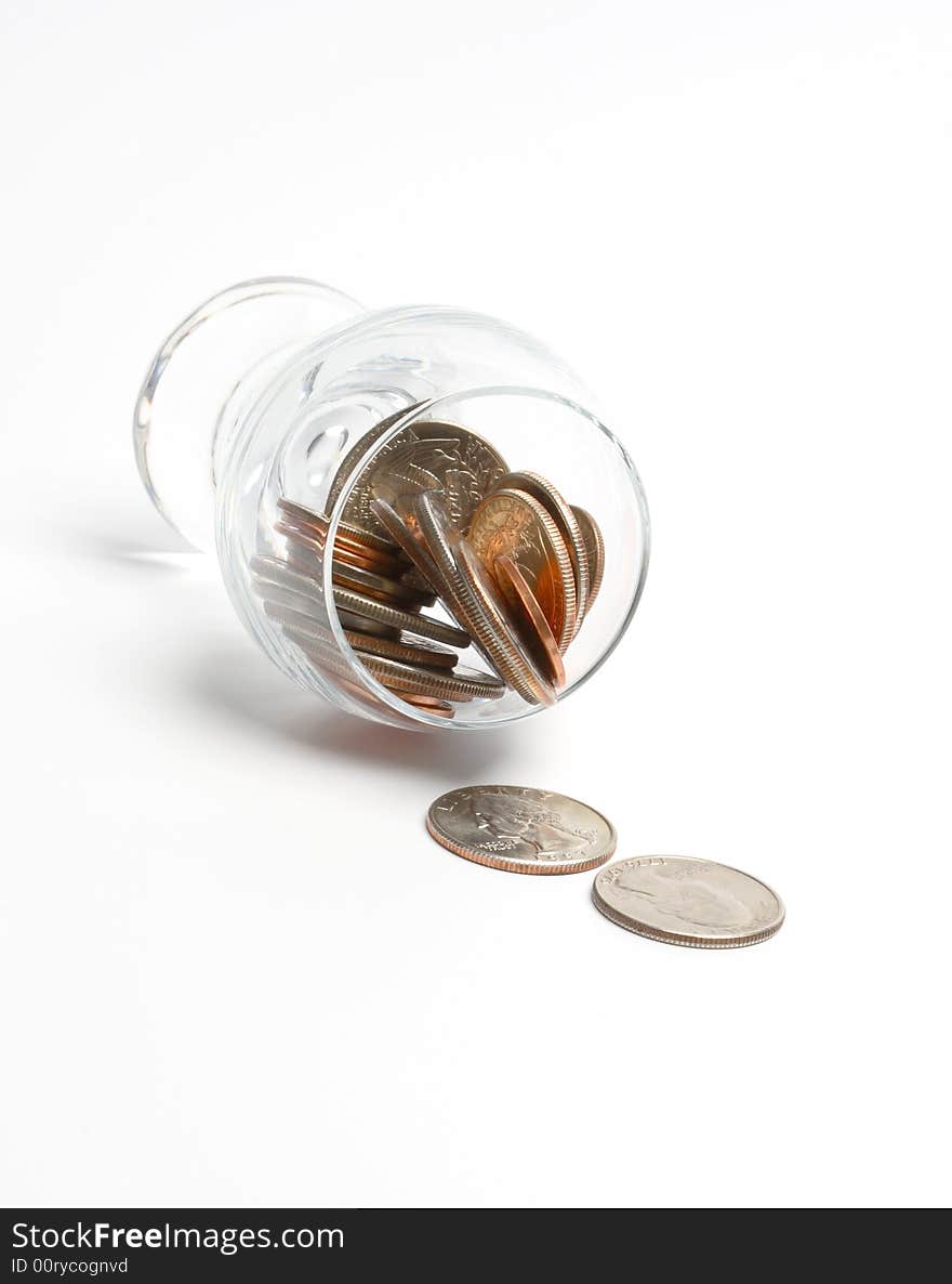 Coins in a glass on a white