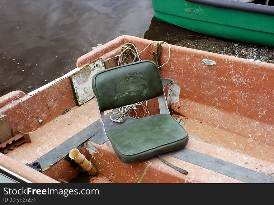 Sport fishing boat with padded seat pulled up onto the beach