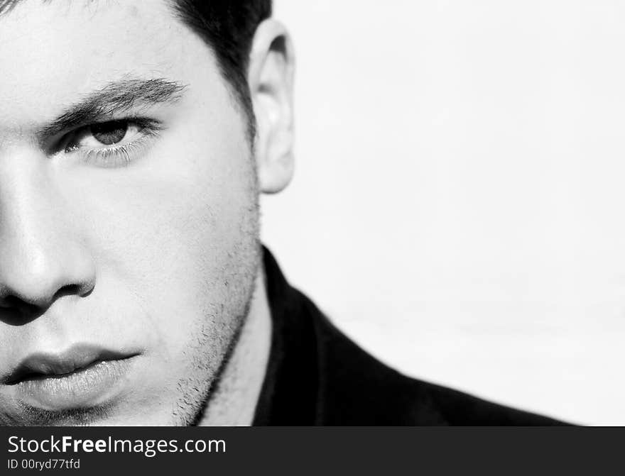 Unshaved handsome man portrait. Black and white isolated on white. Unshaved handsome man portrait. Black and white isolated on white.