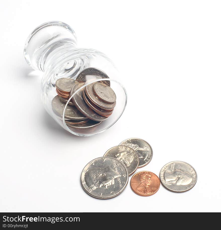 Coins in a glass on a white