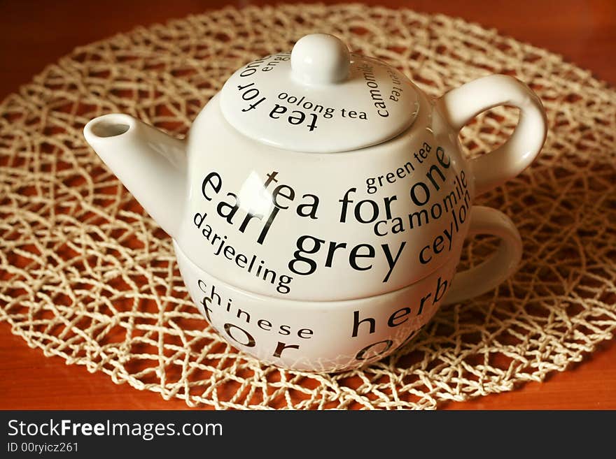 White teapot on a brown wooden table