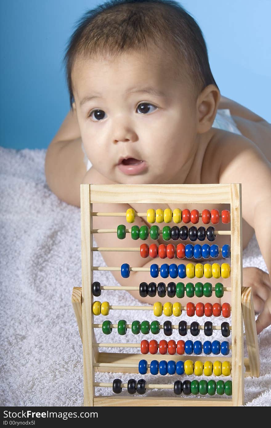 Small charming baby with a calculating machine. Small charming baby with a calculating machine