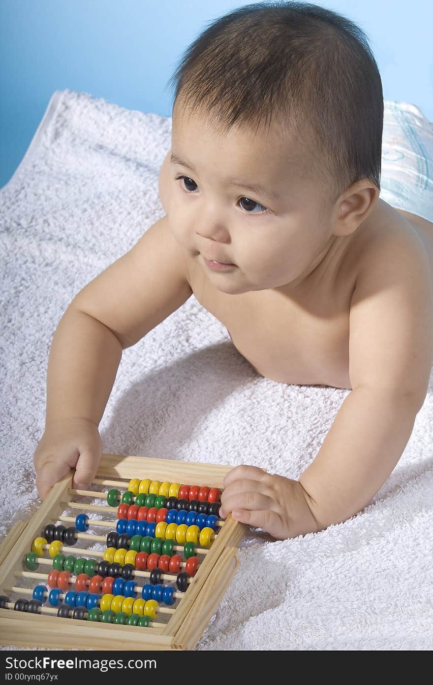 Small charming baby with a calculating machine. Small charming baby with a calculating machine