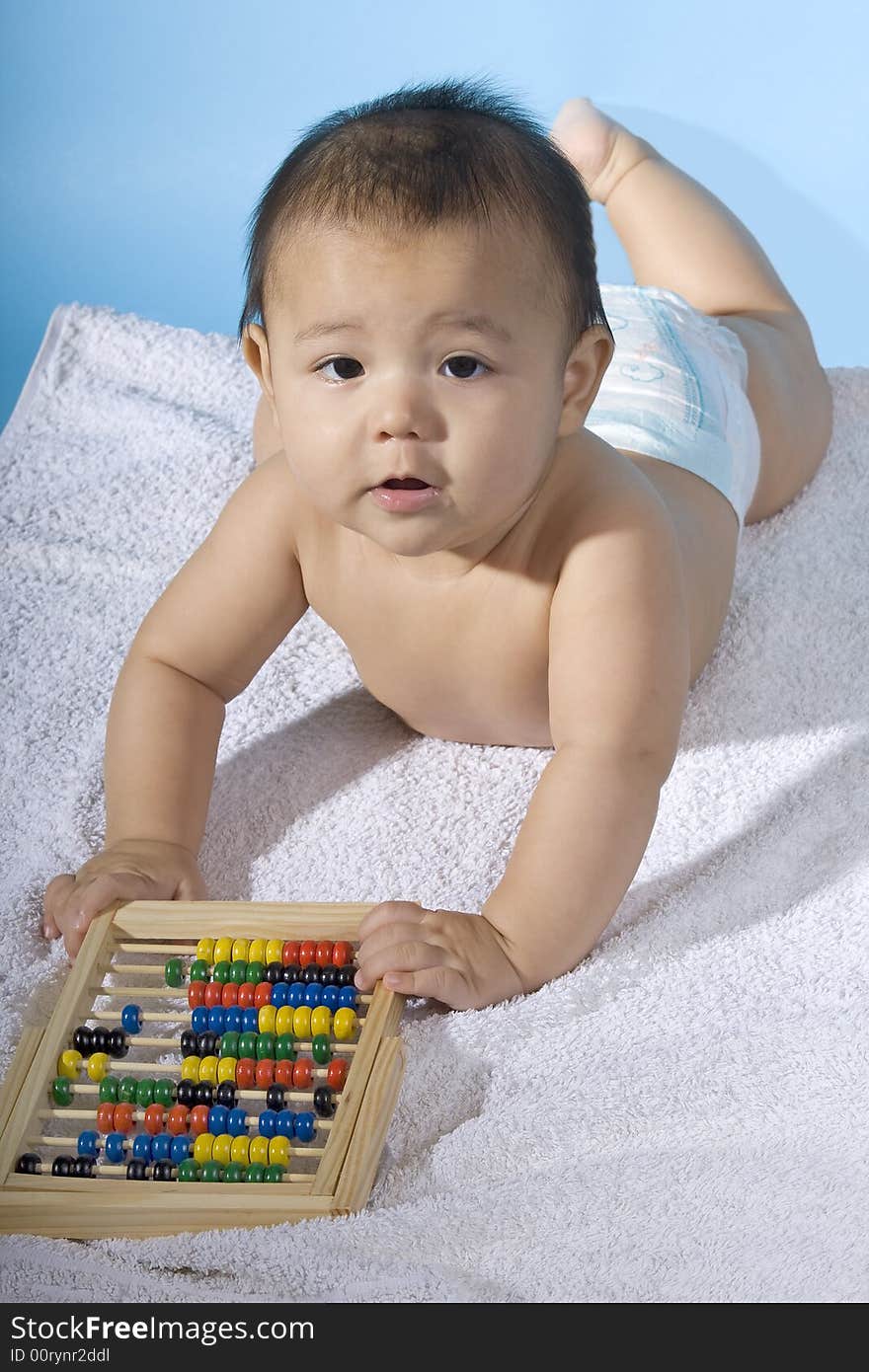 Small charming baby with a calculating machine. Small charming baby with a calculating machine