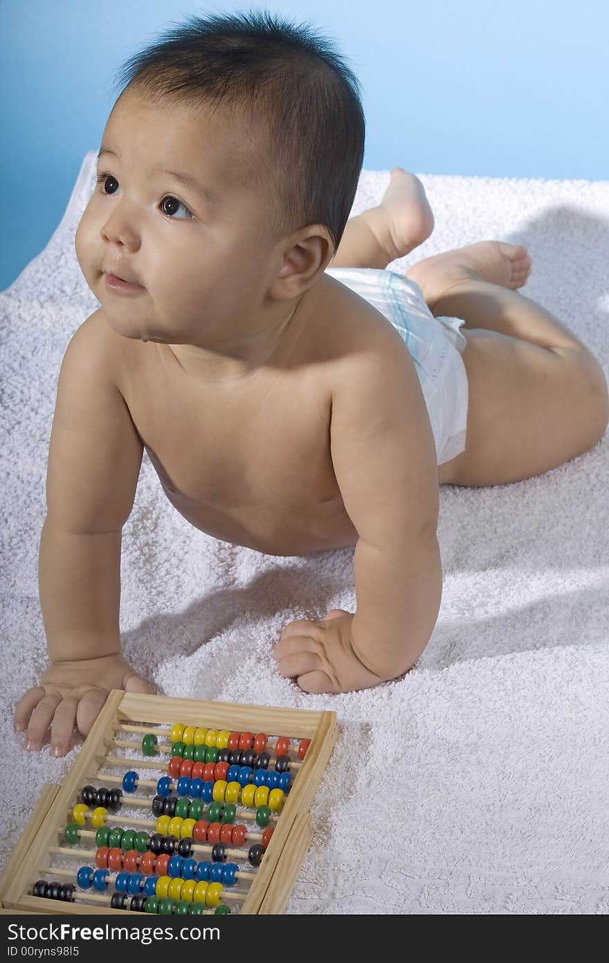 Small charming baby with a calculating machine. Small charming baby with a calculating machine