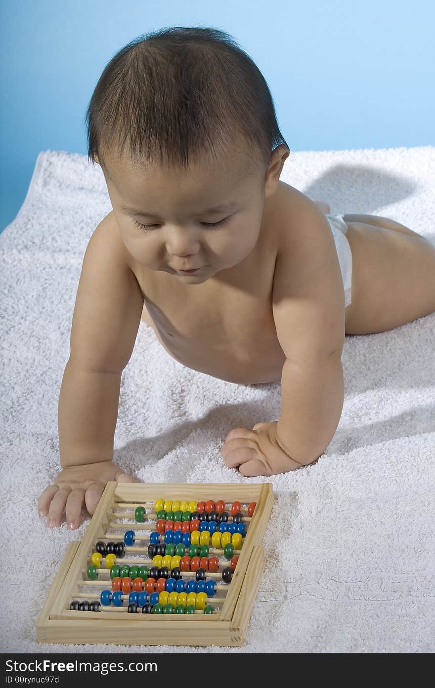 Small charming baby with a calculating machine. Small charming baby with a calculating machine