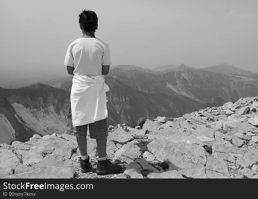 A boy stands atop Monte Vettore, highest peak in the central Apennines, Italy. A boy stands atop Monte Vettore, highest peak in the central Apennines, Italy