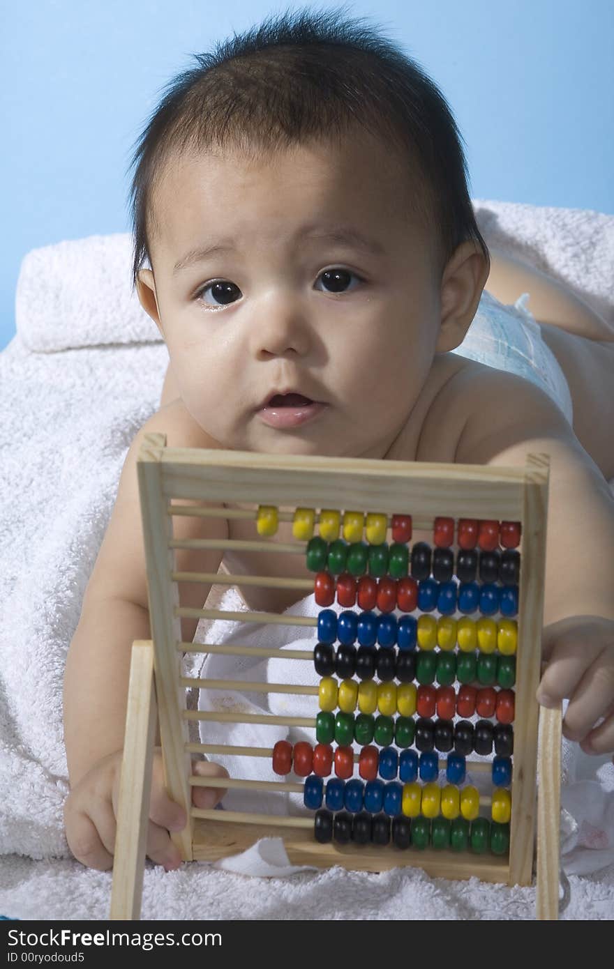 Small charming baby with a calculating machine. Small charming baby with a calculating machine