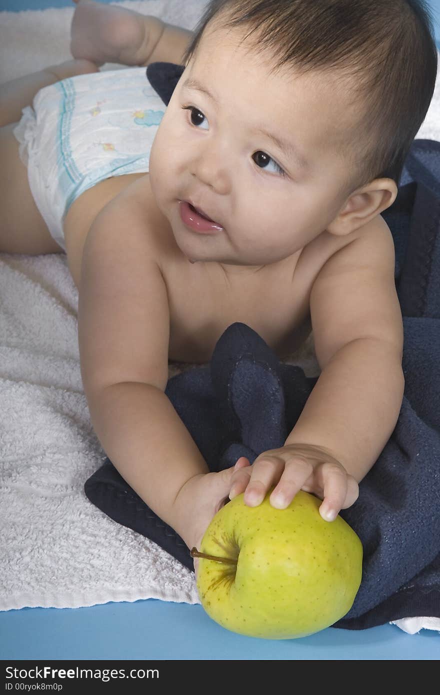 Small charming baby with an apple. Small charming baby with an apple