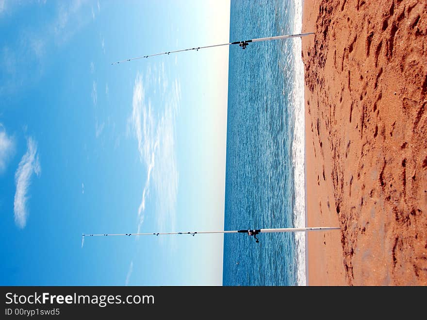 Photographed surf fishing poles on east caost of Florida beach.