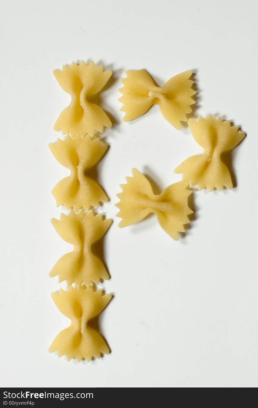 Letter P written with farfalle pasta on white background