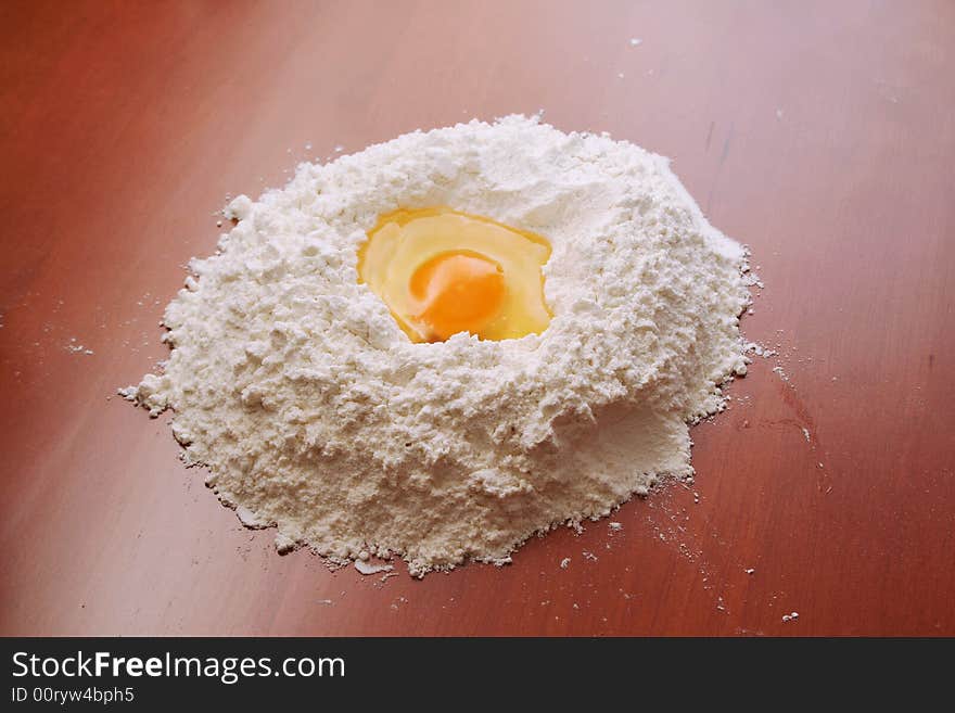 Flour and egg on wooden table. Flour and egg on wooden table